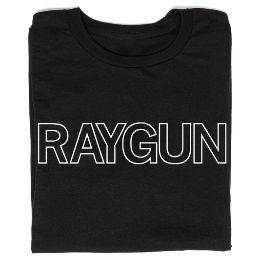 A folded black t-shirt with white outlined text that says, "RAYGUN" across the chest.