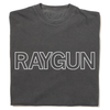 A folded heavyweight grey t-shirt with white outlined text that says, "RAYGUN" across the chest.