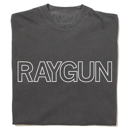 A folded heavyweight grey t-shirt with white outlined text that says, "RAYGUN" across the chest.