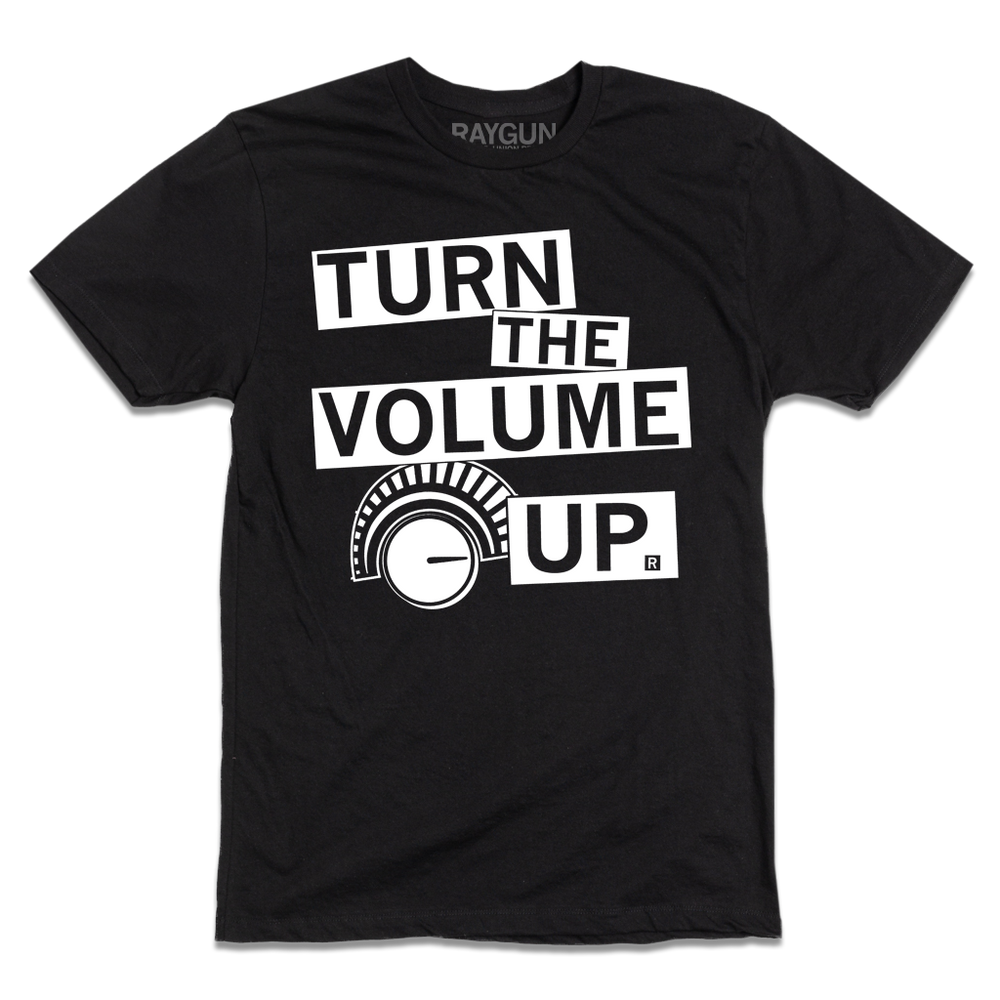 Black shirt with white ink that says "Turn the volume up" to quote Zohran Mamdani's election speech along with an illustration of a volume dial.