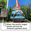 A giant concrete gnome statue holding a shovel stands next to a sign for Elwood, the World’s Largest Gnome, in Ames, Iowa.