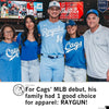 A baseball player in a light blue Royals uniform stands on a stadium field between four family members wearing matching union labor RAYGUN shirts.