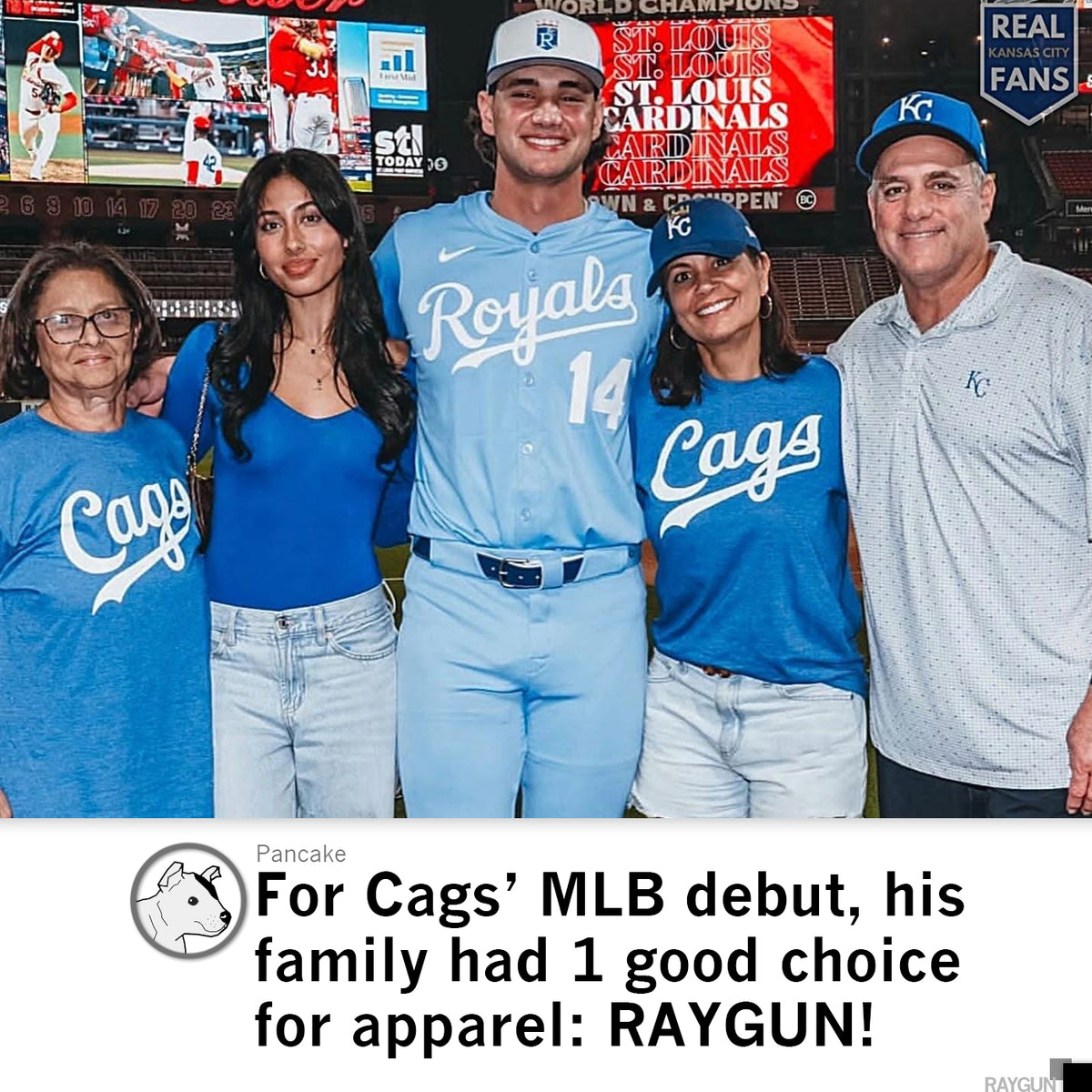 A baseball player in a light blue Royals uniform stands on a stadium field between four family members wearing matching union labor RAYGUN shirts.