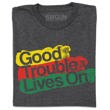 A dark gray Good Trouble T-shirt with the text Good Trouble Lives On printed in yellow, red, and green brushstroke-style blocks.