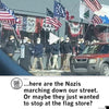 A group of people wearing face masks and dark jackets march down a street carrying historical and American flags, one wearing a Des Moines t-shirt, as a red SUV remains parked nearby.