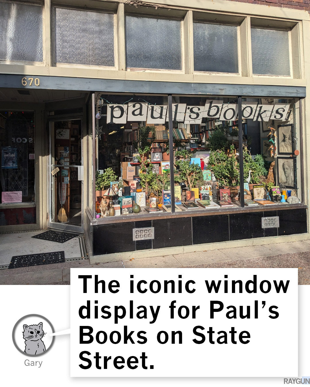 The storefront of Pauls Books on State Street, with books and plants arranged in the display window below a banner reading pauls books, showing a Madison t-shirt and Wisconsin Public Radio gear.