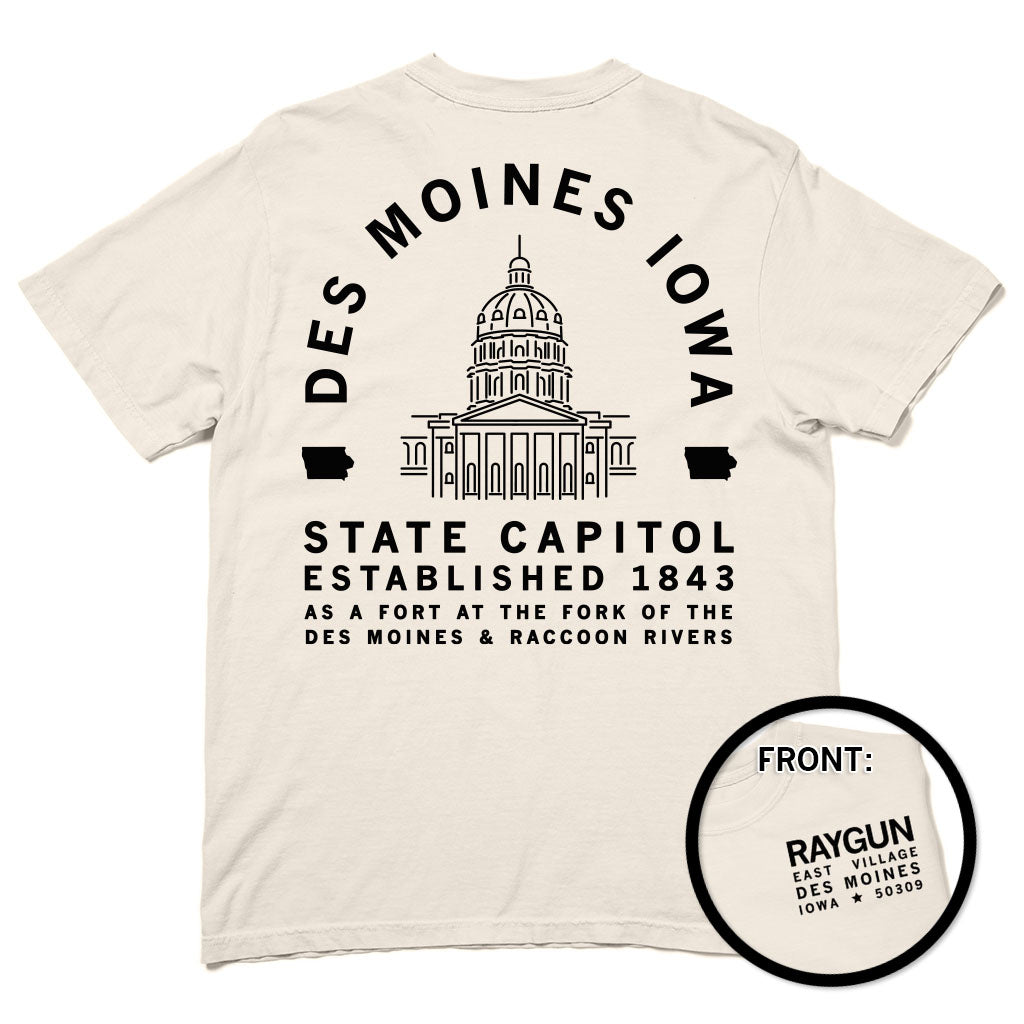 A heavyweight cotton t-shirt with a back print of the Iowa State Capitol and Des Moines Iowa State Capitol Established 1843 text, plus a small front logo for Raygun East Village, Des Moines, Iowa 50309.