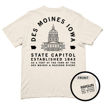 A heavyweight cotton t-shirt with a back print of the Iowa State Capitol and Des Moines Iowa State Capitol Established 1843 text, plus a small front logo for Raygun East Village, Des Moines, Iowa 50309.