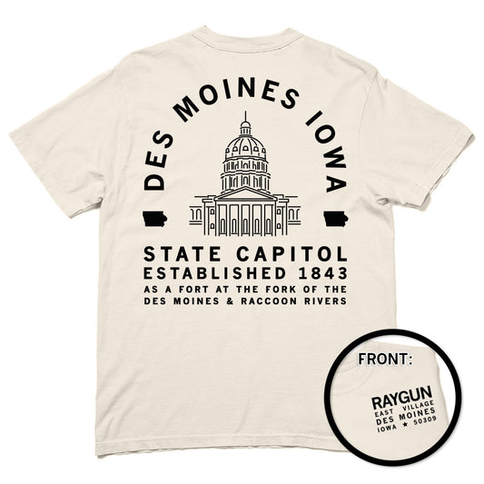 A heavyweight cotton t-shirt with a back print of the Iowa State Capitol and Des Moines Iowa State Capitol Established 1843 text, plus a small front logo for Raygun East Village, Des Moines, Iowa 50309.