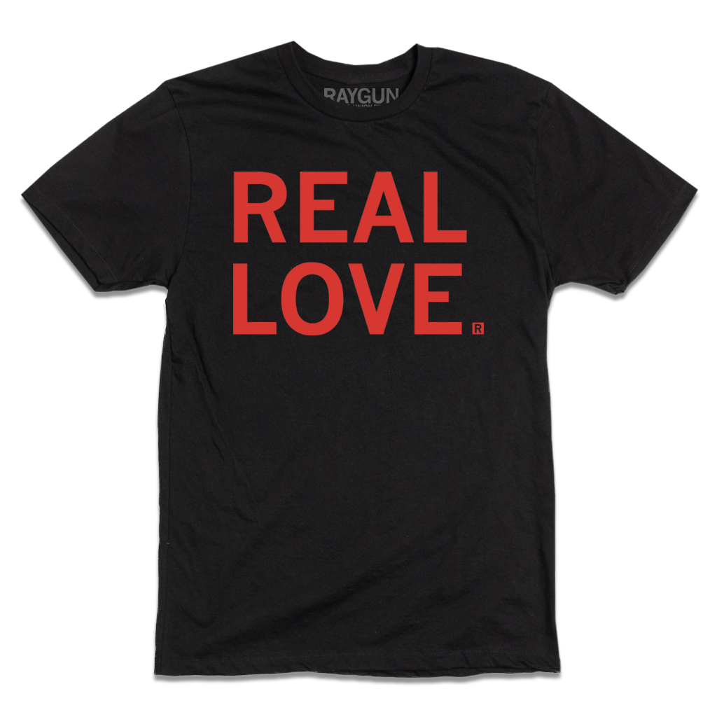 Short sleeve black t-shirt with left aligned red print text that reads "REAL LOVE"