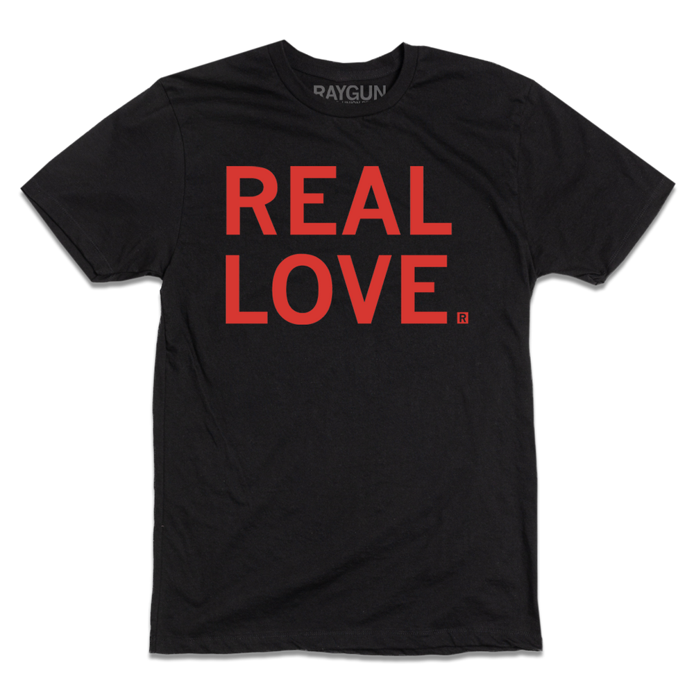 Short sleeve black t-shirt with left aligned red print text that reads "REAL LOVE"