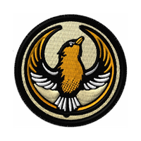 A circular embroidered patch with the Rebel Goldfinch Alliance Logo. It uses a goldfinch with outstretched wings to mimic the shape of the Star Wars Rebel Alliance Logo. The goldfinch black, gold, and white. The border of the patch is black and the rest of the patch is very light gold.