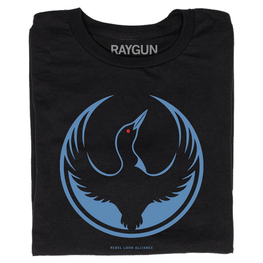 A folded black t-shirt with the Rebel Loon Alliance Logo. It features a loon with outstretched wings to mimic the shape of the Star Wars Rebel Alliance Logo. The loon is printed blue & black with red eye.
