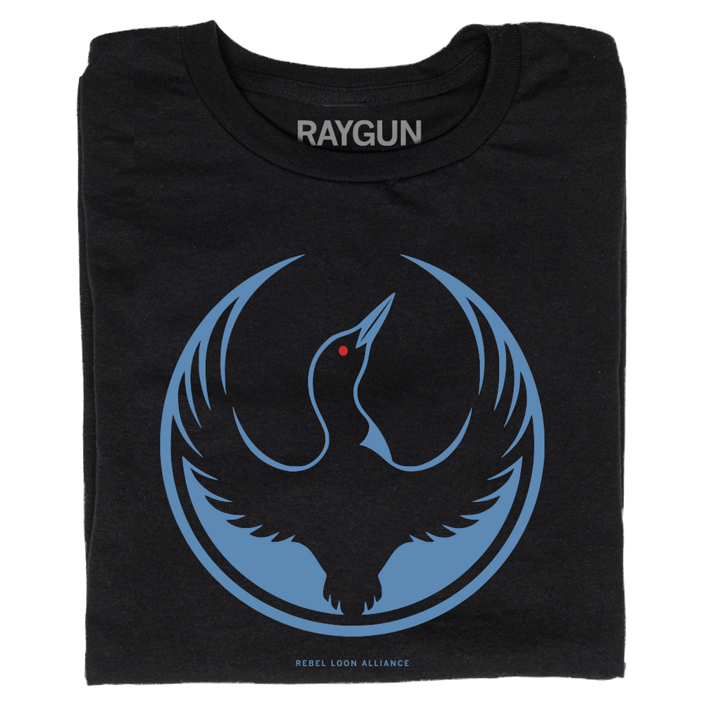 A folded black t-shirt with the Rebel Loon Alliance Logo. It features a loon with outstretched wings to mimic the shape of the Star Wars Rebel Alliance Logo. The loon is printed blue & black with red eye.