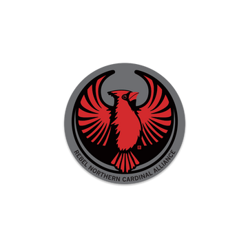 Circular Rebel Northern Cardinal emblem featuring a stylized red cardinal with spread wings and the text REBEL NORTHERN CARDINAL ALLIANCE along the bottom edge, in the style of a RAYGUN vinyl sticker.
