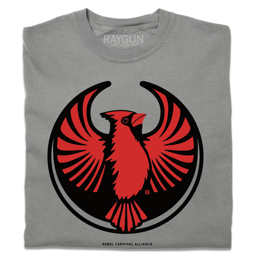 A folded heavyweight grey shirt with the Rebel Northern Cardinal Alliance Logo. It uses a northern cardinal with outstretched wings to mimic the shape of the Star Wars Rebel Alliance Logo. The northern cardinal is printed in red and black ink.