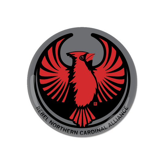 A circular RAYGUN button emblem featuring a red cardinal with wings spread inside a black circle, surrounded by a gray border with the text REBEL NORTHERN CARDINAL ALLIANCE.