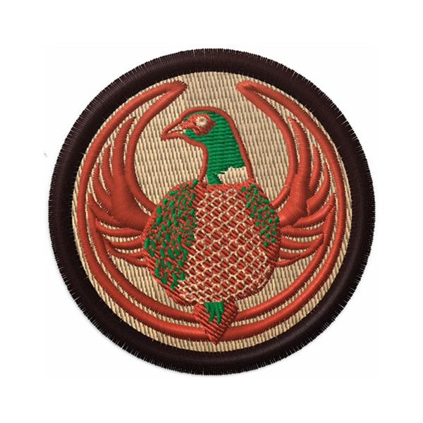 An embroidered circle patch with the Rebel Pheasant Alliance Logo. It uses a pheasant with outstretched wings to mimic the shape of the Star Wars Rebel Alliance Logo. The pheasant green and light brown. The border of the patch is a dark brown and the rest of the patch is beige.