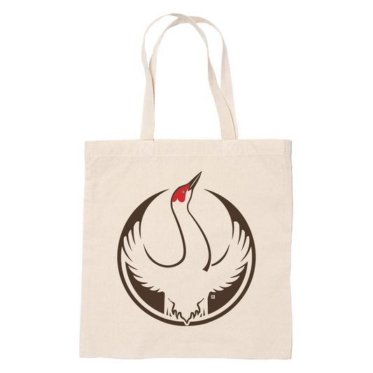 A canvas tote bag with the Rebel Sandhill Crane Alliance Logo. It uses a sandhill crane with outstretched wings to mimic the shape of the Star Wars Rebel Alliance Logo. The bird is printed in brown, beige, and red.