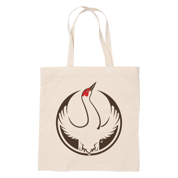 A canvas tote bag with the Rebel Sandhill Crane Alliance Logo. It uses a sandhill crane with outstretched wings to mimic the shape of the Star Wars Rebel Alliance Logo. The bird is printed in brown, beige, and red.