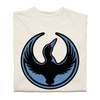 A folded heavyweight cream shirt with the Rebel Loon Alliance Logo. It uses a loon with outstretched wings to mimic the shape of the Star Wars Rebel Alliance Logo. The loon is printed blue & black with red eye.