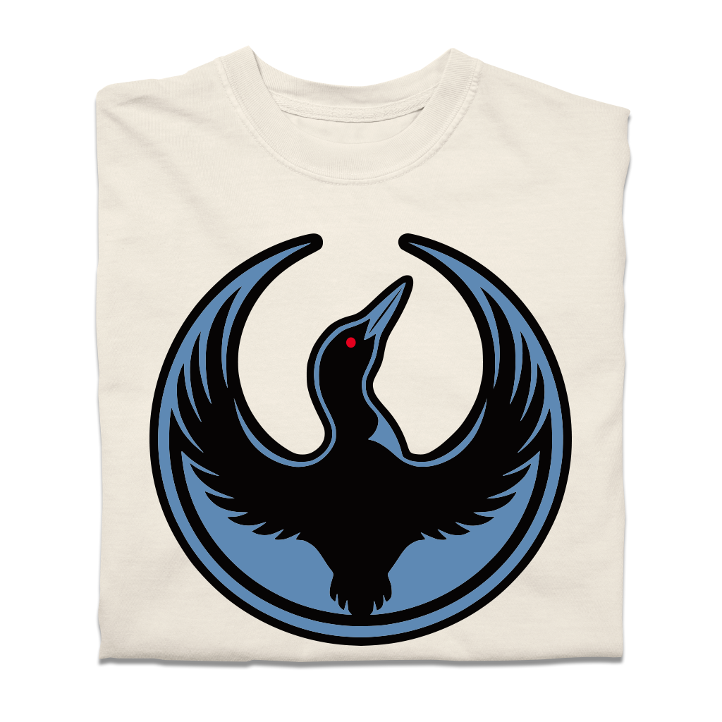 A folded heavyweight cream shirt with the Rebel Loon Alliance Logo. It uses a loon with outstretched wings to mimic the shape of the Star Wars Rebel Alliance Logo. The loon is printed blue & black with red eye.