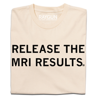 A folded cream t-shirt with blank ink text that reads "release the MRI results"
