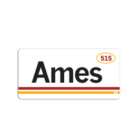 Retro style rectangular sticker. White base with a yellow oval in the top right surrounding "515" in red print. Black text to the left says, "Ames" with red and yellow lines below that.