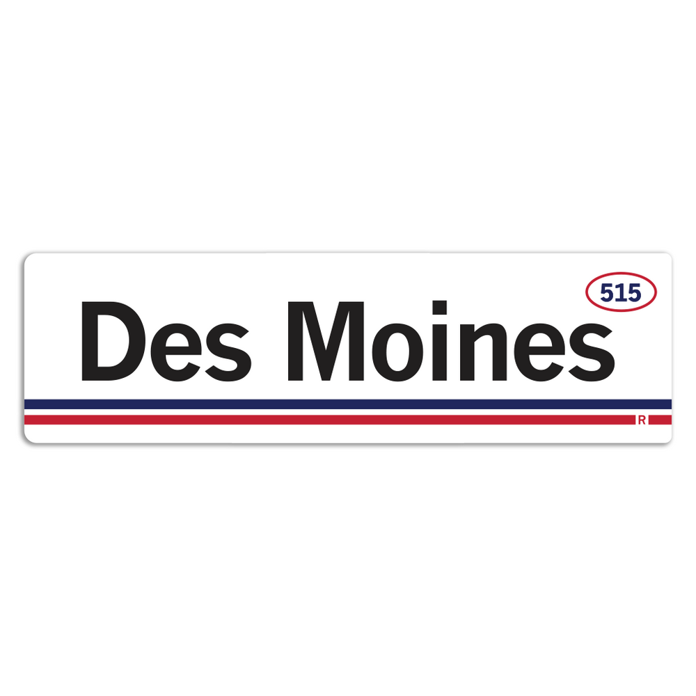 Retro style rectangular sticker. White base with a red oval in the top right surrounding "515" in blue print. Black text to the left says, "Des Moines" with blue and red lines below that.