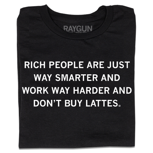 A folded black t-shirt with centered white ink text that says, "Rich people are just way smarter and work way harder and don't buy lattes."