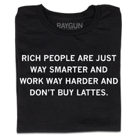 A folded black t-shirt with centered white ink text that says, "Rich people are just way smarter and work way harder and don't buy lattes."