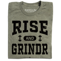 A folded heather military green t-shirt with black ink styled like a gym shirt with faded text that reads "Rise and Grindr"