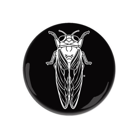 A black RAYGUN circular pin featuring a white line art illustration of a cicada.
