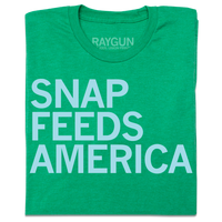 A folded Heather Kelly Green shirt with ice blue text that reads "Snap feeds America" left aligned