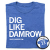 Heather royal blue Saige Damrow t-shirt with white text that reads DIG LIKE DAMROW, SAIGE DAMROW, and 13, with an inset showing the back of the shirt printed with DAMROW 13.