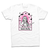 Short sleeve white t-shirt with pink & black print depicting Dolly Parton with her arms outstretched. A stained glass frame is around her, with a pink sun behind her, black butterflies around her, and text at the bottom that says, "SAINT DOLLY."