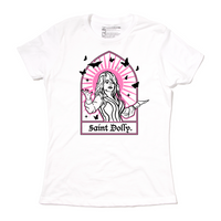 Women's size white t-shirt with pink & black print depicting Dolly Parton with her arms outstretched. A stained glass frame is around her, with a pink sun behind her, black butterflies around her, and text at the bottom that says, "SAINT DOLLY."