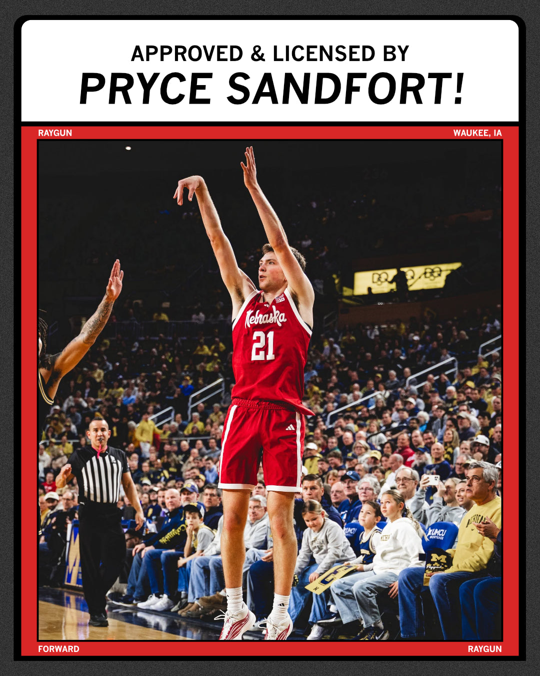 Nebraska basketball player Pryce Sandfort, wearing number 21, jumps to shoot a basketball in a crowded arena.