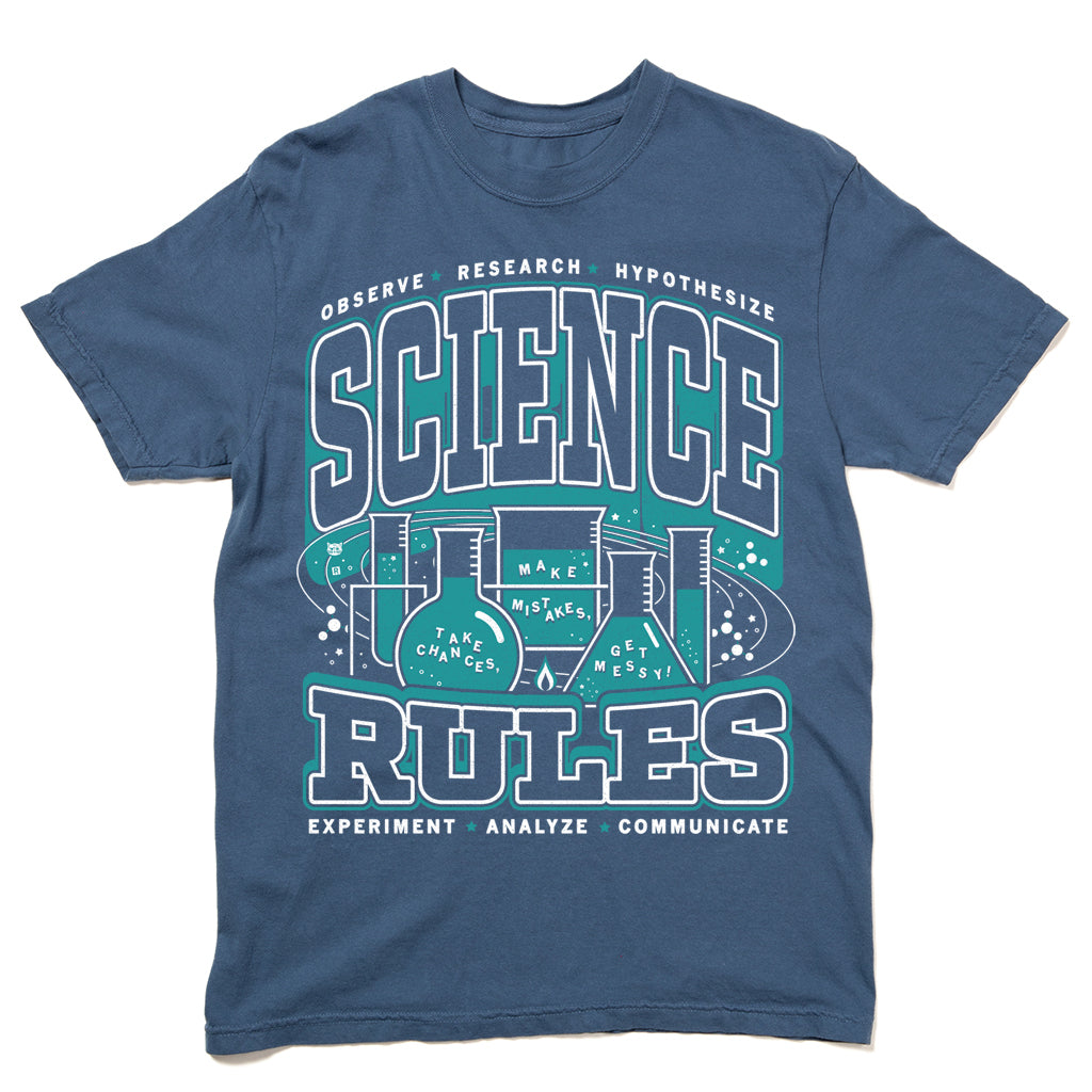 Blue heavyweight cotton science t-shirt featuring a graphic that reads Science Rules surrounded by laboratory glassware and the phrases Observe, Research, Hypothesize, Experiment, Analyze, Communicate, Make mistakes, Take chances, and Get messy!.