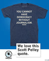 A union made, dark blue heathered T-shirt printed with the text, You cannot have democracy without journalism, attributed to Scott Pelley, with a speech bubble featuring a dog logo that says, We love this Scott Pelley quote.