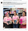 Three people wearing matching pink, union made, sweatshop free shirts that say MY JOB IS... BOOKS each hold a different book in front of a bookstore shelf.