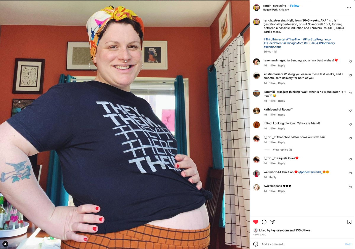 A smiling pregnant person wearing a headscarf and a gender pronoun T-shirt with the words THEY THEM printed repeatedly, posing with their hands on their hips and belly.