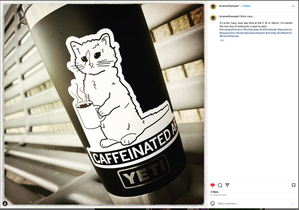 A black Yeti tumbler featuring a Caffeinated AF vinyl sticker of a cartoon cat holding a steaming mug of coffee.