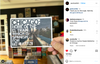 A hand holds a Chicago postcard featuring a photo of an elevated train track with the text, Chicago: Home of the El train, which is Spanish for the train.