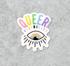 A Sarah Epperson sticker reading QUEER VISIBILITY above a stylized eye with a rainbow iris.