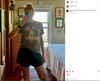 A woman in a mirror selfie wearing an olive green union-made t-shirt with a graphic of a cicada and the words WE ALL SCREAM.