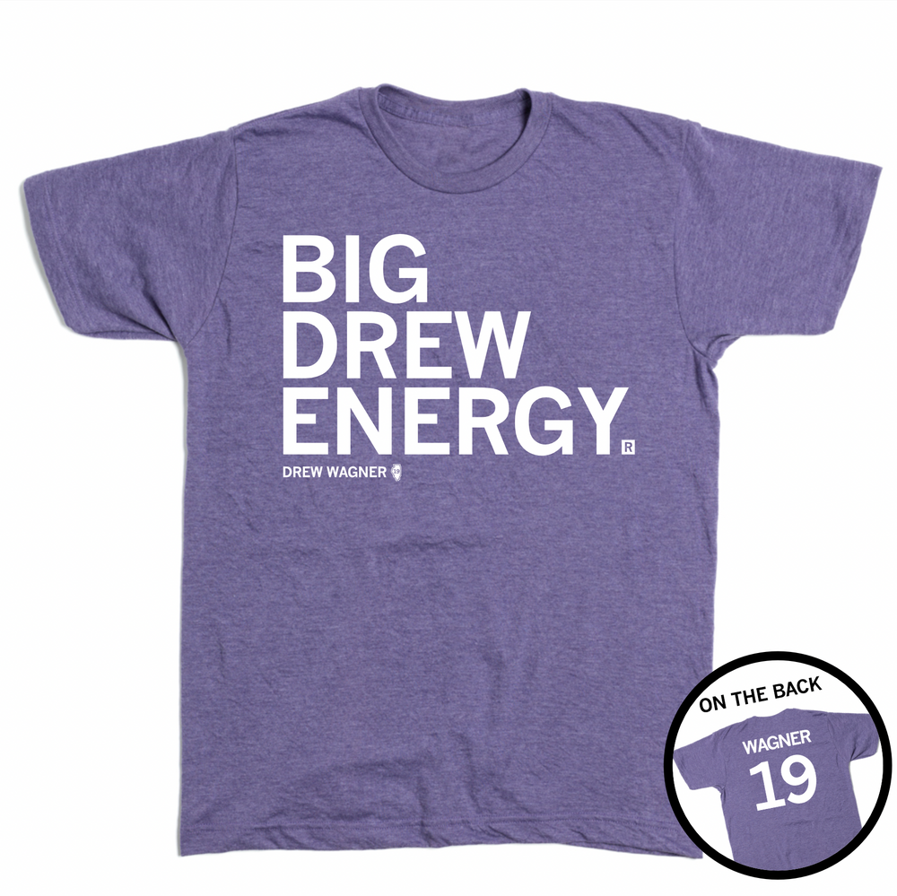 Short-sleeve heather purple t-shirt with left-aligned white text that reads "BIG DREW ENERGY" above smaller text that says, "DREW WAGNER" with a small outline of Illinois that has 19 in its center. A circle image in the bottom right corner shows the back of the t-shirt printed like a jersey with "WAGNER" above the number 19.