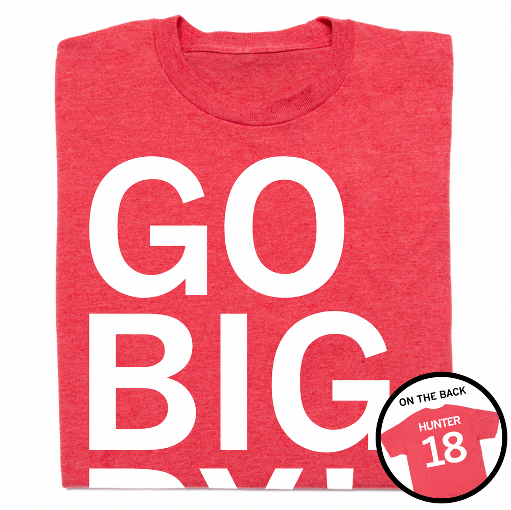 A folded heather red t-shirt with white ink that says, "GO BIG RY" in giant print above small text that reads "RYAN HUNTER" with an outline of Nebraska to the right. A circle image overlayed in the bottom right corner shows the back printed like a sports jersey with "HUNTER" above 18.