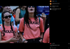 Two young women in matching pink gun reform t-shirts stand in a crowd at a protest, with a Brady organization sign visible in the background.