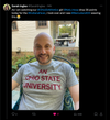 A smiling man wearing a heather grey Ohio State University t-shirt.